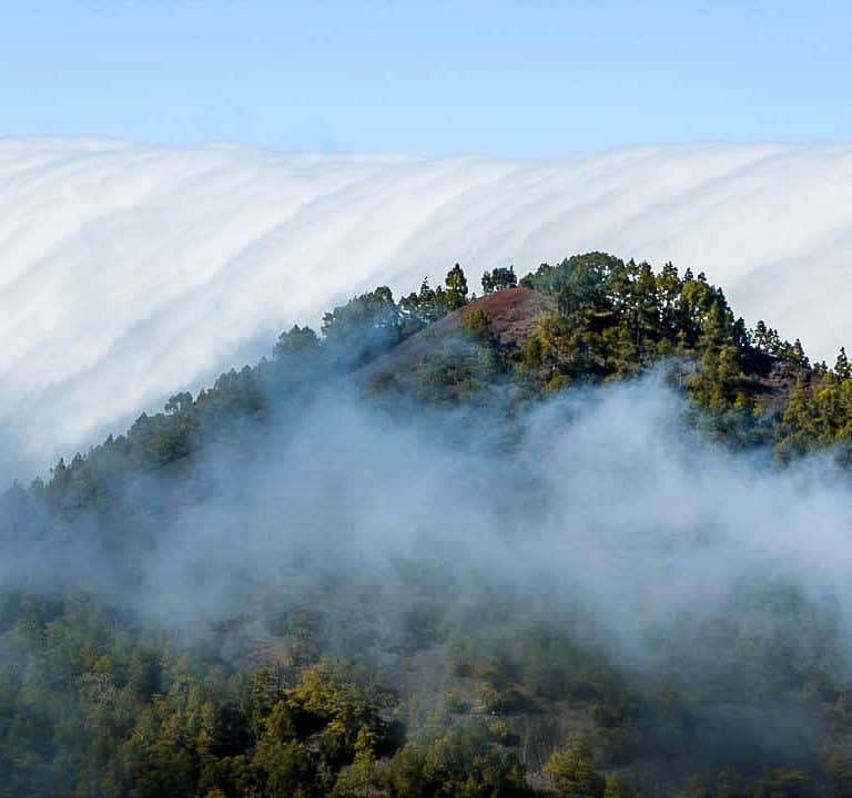 Cloud waterfall phenomenon in La Palma. La Palma - The Hidden Gem of the Canary Islands, article by Kiss My Backpack at https://www.kissmybackpack.com/