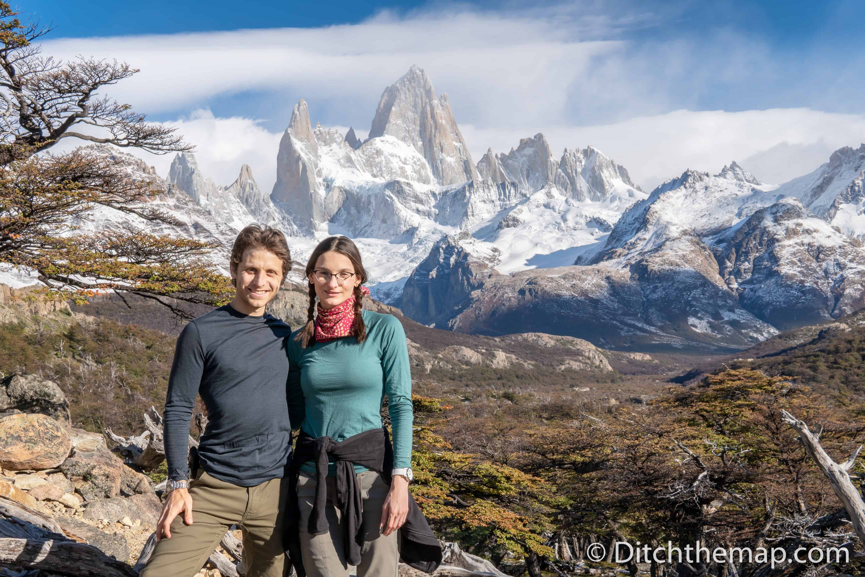 A couple hiking on a snowy mountain Fitz Roy in El Chalten