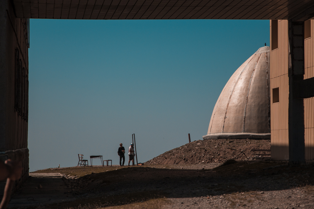 Part of Peak Botev's weather station with two silhouetteс